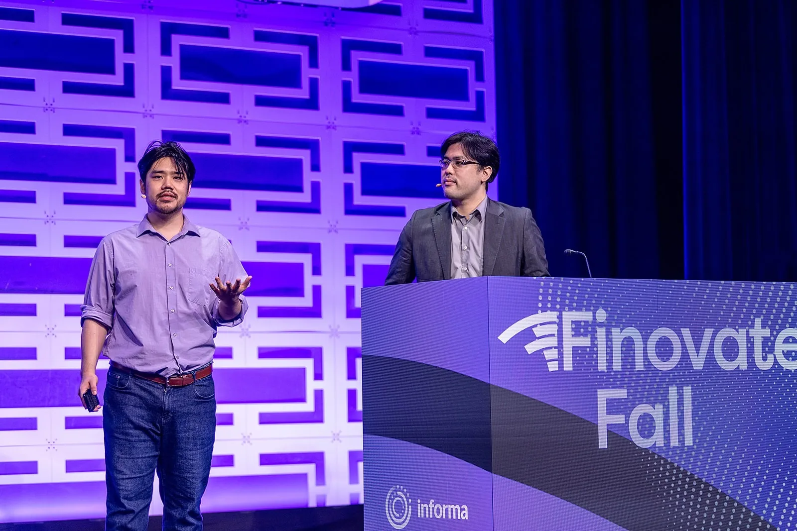 Delfi’s two presenters at the lectern on the FinovateFall 2026 main stage.